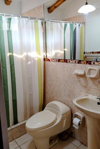 a bathroom with a toilet and a sink at Rural retreat pool, 6ppl - 5min beach - SuperHost in Mala