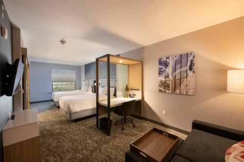 a hotel room with a bed and a desk at SpringHill Suites by Marriott Colorado Springs Downtown in Colorado Springs