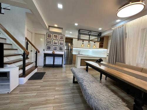 a living room with a bench and a staircase at Cozy Home in Quiet Subdivision in Malolos