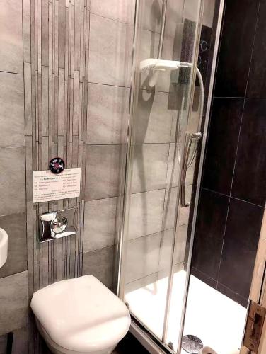 a bathroom with a shower and a toilet at 301 Self contained studio in heart of London in London