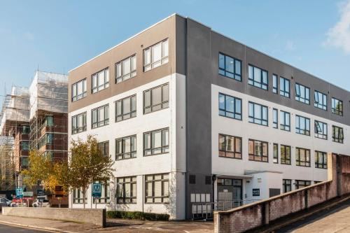 a large white building with windows on a street at Serenity Suite in Haywards Heath