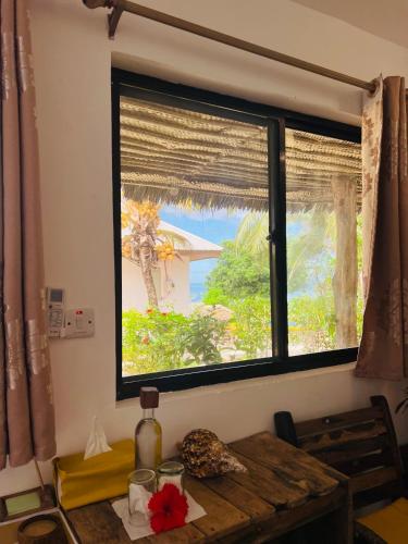 a window in a room with a wooden table and a table sidx sidx sidx at Z-Love Zanzibar in Kiwengwa