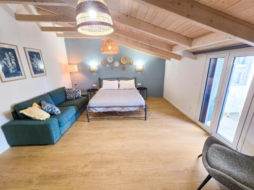 a living room with a bed and a couch at Casa Burano in Lefkada Town