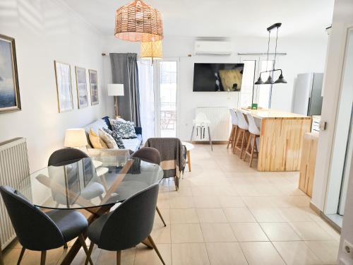 a living room with a glass table and chairs at Casa Burano in Lefkada Town