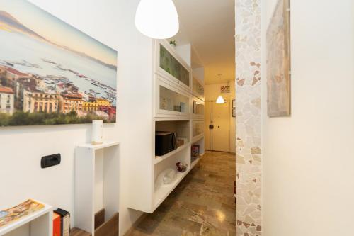 a hallway with white shelves and a painting on the wall at L'Anfiteatro di Pompei B&B in Pompei