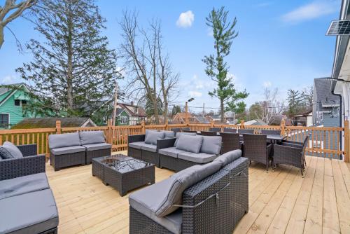 a patio with couches and chairs on a wooden deck at Martha Vineyard in Lansing