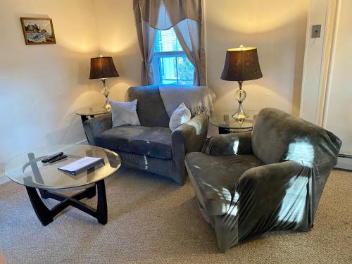 a living room with a couch and a chair and a table at Private Entrance Residential Portland in Portland