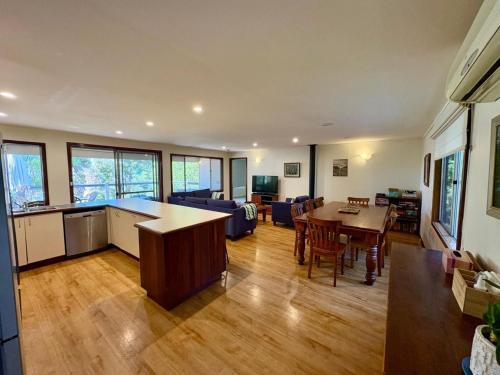 a living room with a kitchen and a dining room at Dunsborough Delight in Dunsborough