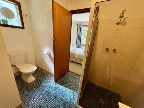a bathroom with a toilet and a shower at Dunsborough Delight in Dunsborough