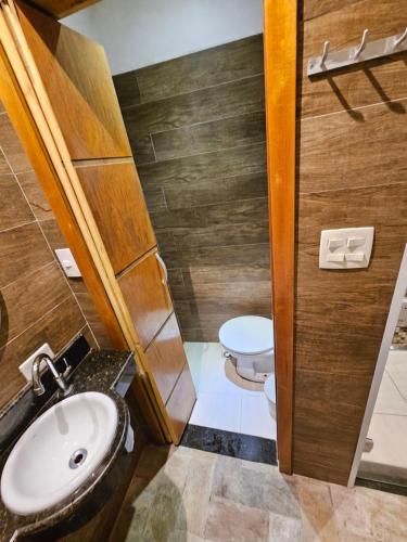 a bathroom with a sink and a toilet at Hotel Estrela Carapicuíba in Carapicuíba