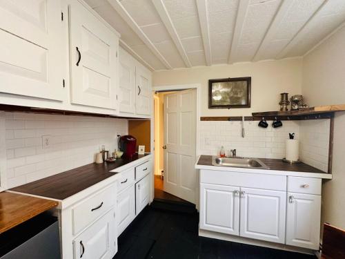 a kitchen with white cabinets and a sink at Walkable near downtown 1 Bedroom in Portland