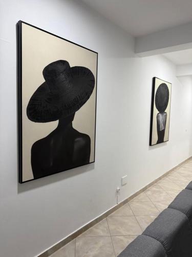 a painting of a person wearing a hat on a wall at Casa Cucuia in Praia