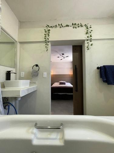 a bathroom with a tub and a sink and a bedroom at Comoda habitación centrica in Aguascalientes