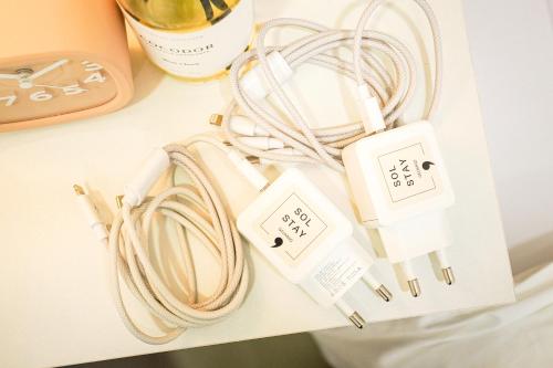 a pile of electrical devices on a table at Sol Stay in Seoul