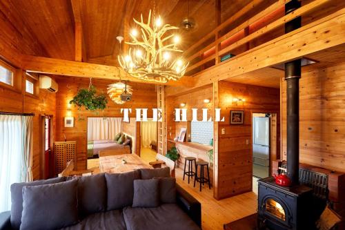 a living room with a couch and a stove at THE HILL Katsuura in Katsuura