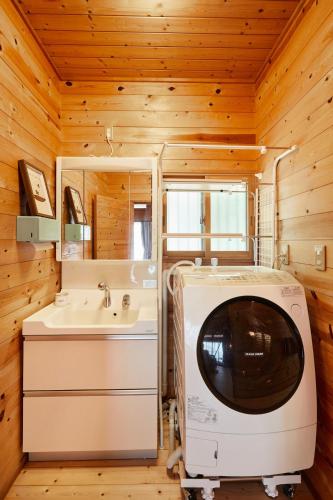 a bathroom with a sink and a tv in it at THE HILL Katsuura in Katsuura