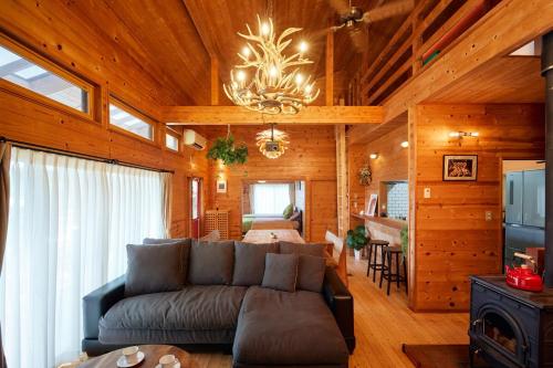 a living room with a couch and a chandelier at THE HILL Katsuura in Katsuura
