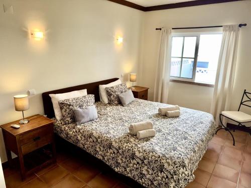 a bedroom with a bed with two pillows on it at Villa in Benagil with private pool in Benagil