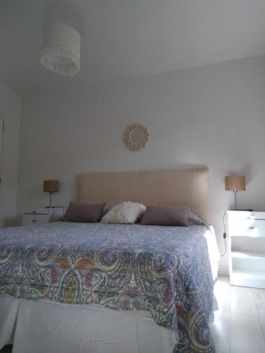 a bedroom with a bed and two night stands at Ntra Sra de los Angeles in Salta