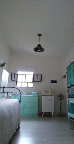 a bedroom with a bed and a dresser in a room at Ntra Sra de los Angeles in Salta