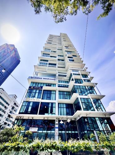 a tall white building with lots of windows at Sunrise @ Gurney in George Town