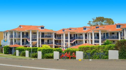 a row of apartment buildings with orange roofs at 306 South Pacific Apartments in Port Macquarie
