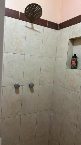 a shower with a glass door in a bathroom at Sicarú Suites in Puerto Escondido