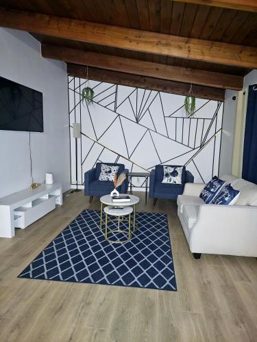 a living room with a couch and a table at P&N Suites - Queen Room- DUBAI in Edmonton