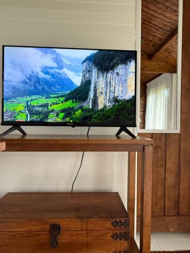 a flat screen tv sitting on top of a table at Jacaranda Cottage 5 min by Train or 7 min drive to Parramatta City in Wentworthville