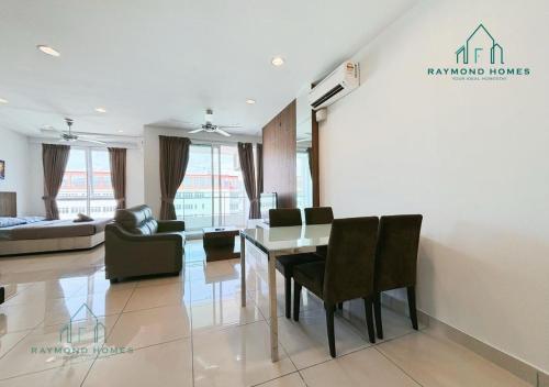a living room with a table and chairs and a couch at Gurney Drive Mansion One Serviced Apartment in George Town
