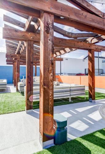 a wooden pergola with benches on a lawn at Central Buckhead Suite in Atlanta