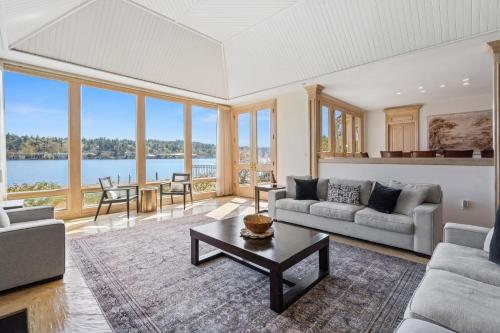 a living room with a couch and a table at Stunning Waterfront Mansion with Pool and Hottub in Mercer Island
