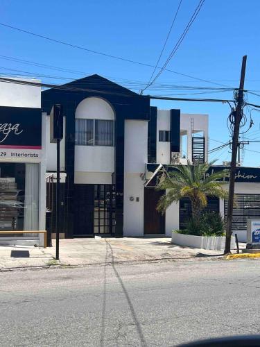 a blue and white building on the corner of a street at Departamento Residencial Campestre in Chihuahua