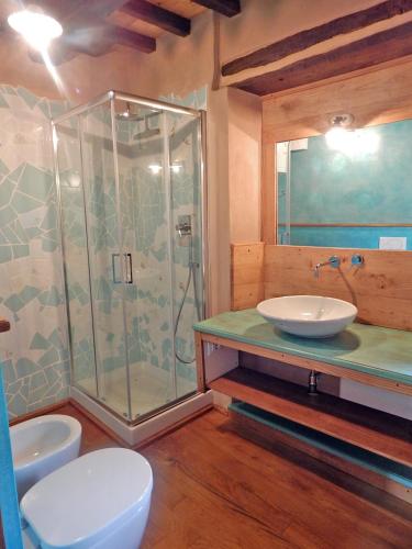a bathroom with two sinks and a glass shower at Pieve di Cà Maggiore in Firenzuola