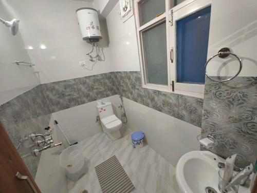 a small bathroom with a toilet and a sink at Fair lawns Home Stay in Shimla
