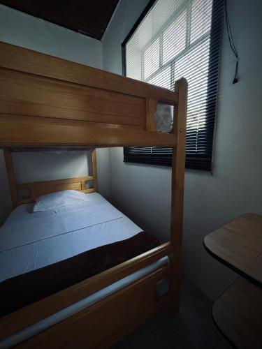 a bunk bed in a room with a window at Hostal Mamaquilla in Pasto