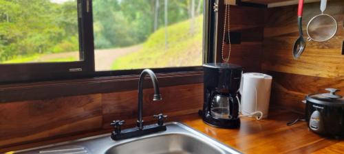 a kitchen counter with a sink and a window at Ceibo Lodge in Bijagual