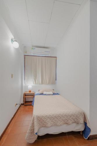 a bedroom with a bed in a white room at Hotel el Tajalin in Montezuma