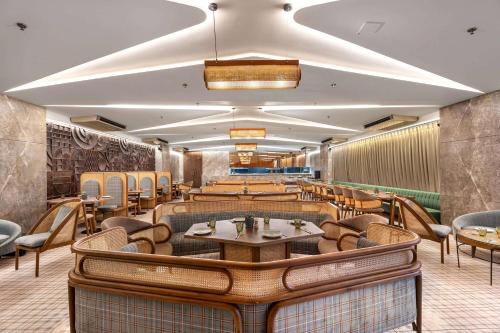 a restaurant with tables and chairs in a room at Ramada Encore by Wyndham Ambala GT Road in Ambāla