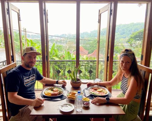 a man and a woman sitting at a table with food at Sesatha lake Kandy in Kandy