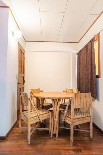 a dining room with a wooden table and chairs at Hotel el Tajalin in Montezuma