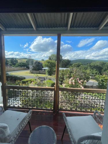 a screened in porch with a view of a garden at Islay House - stylish villa in historic Lawrence in Lawrence