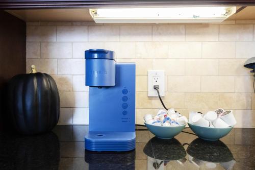 a blue blender on a counter next to two bowls of candy at Sky-Rise Apartments in Los Angeles