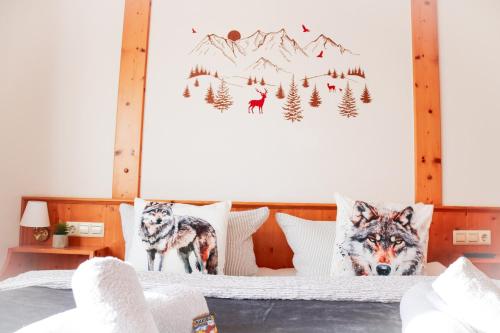 a bedroom with a bed with wolf pillows at House of Happiness by apartmentglück in Schluchsee