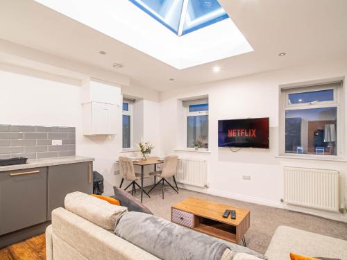 a living room with a couch and a table at Hayy ApartHotels Dealhouse in Huddersfield