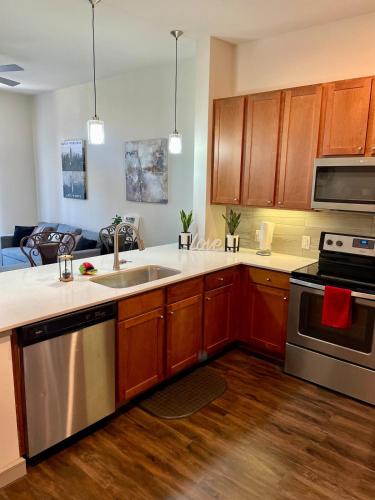 a kitchen with a sink and a stove top oven at Houston Luxury 1BR-3BD-Pool-Gym in Houston