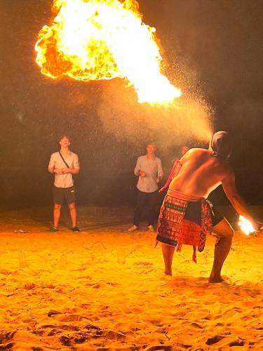 a man with a fire show on the beach at Dolphin Bay Island Resort 海豚岛 in Kota Belud