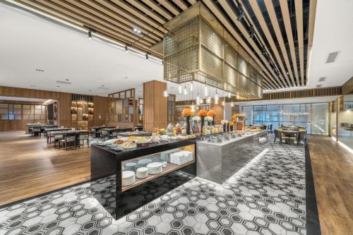 a restaurant with a buffet in a building at YTL OuYue International Hotel in Wenzhou