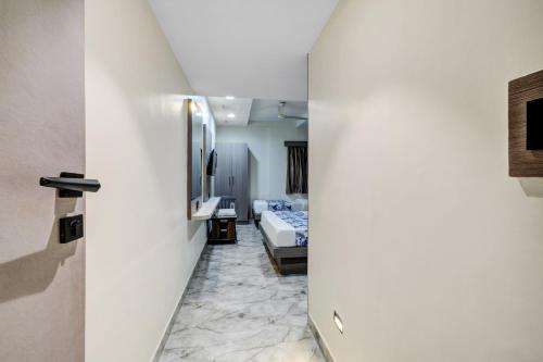 a hallway with a room with a bed and a mirror at Hotel Royal Stay, Pakwan Sg Highway in Ahmedabad