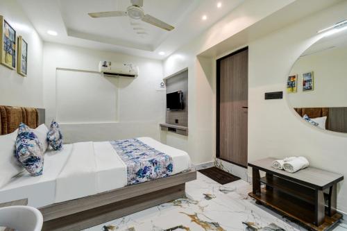 a bedroom with a bed and a mirror at Hotel Royal Stay, Pakwan Sg Highway in Ahmedabad